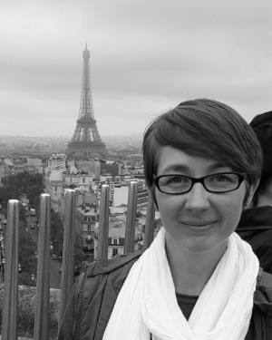Black and white photo of Kerry, Rotherham Sendiass Service Lead, in front of the Eiffel Tower in Paris